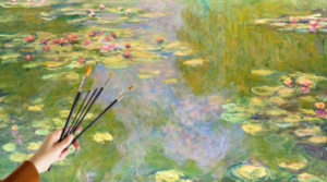 a hand holding paint brushes and a painting of a pond with water lillies done in monet's style